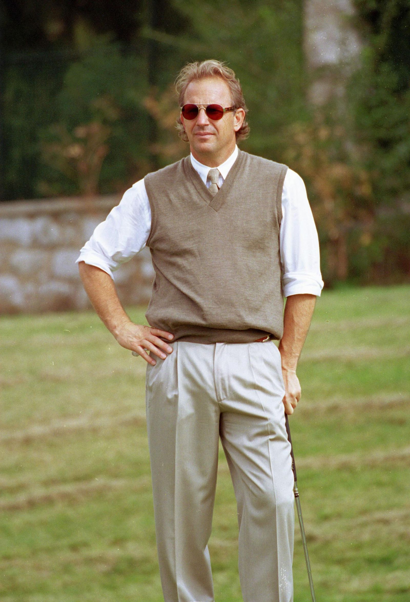 Image may contain Kevin Otto Adult Person Accessories Glasses Formal Wear Tie Clothing Vest Walking and Pants