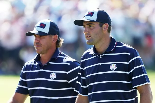 Scottie Scheffler and Brooks Koepka of Team United States walk from the ninth green during the Friday afternoon fourball matches of the 2023 Ryder Cup at Marco Simone Golf Club on September 29, 2023 in Rome, Italy