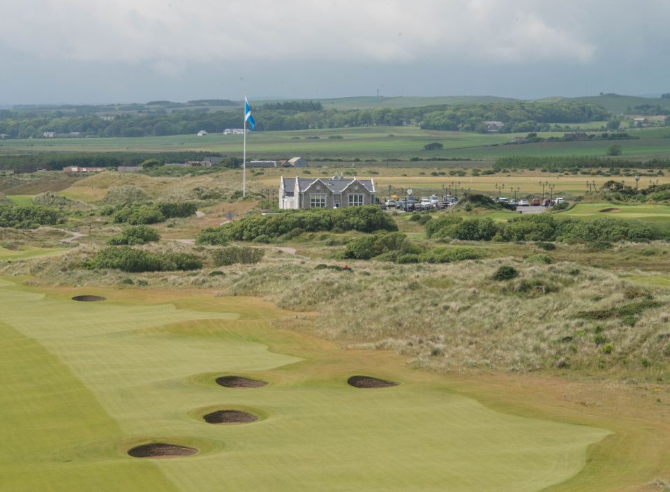 Aerial view of a golf course with clubhouse.