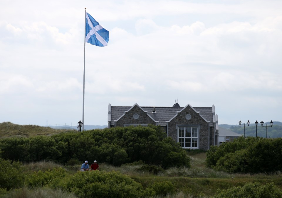 Large Scottish flag flying near a clubhouse.