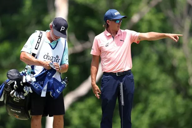 Rickie Fowler of the United States talks to his caddie on the fifth green during the first round of the Charles Schwab Challenge 2025 at Colonial Country Club