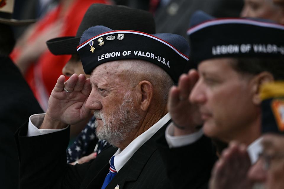 Veterans salute in the amphitheatre at the Tomb of the Unknown Soldier at the start of a ceremony in Arlington National Cemetery in Arlington, Virginia, on Memorial Day, May 26, 2025.