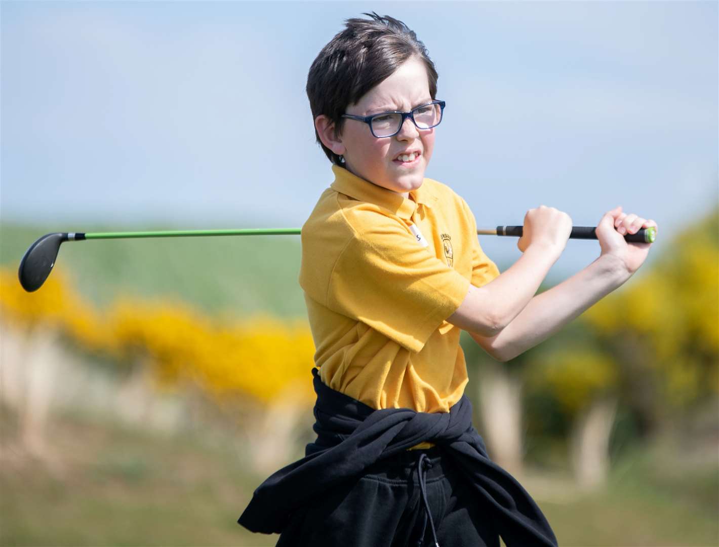 Lewis from Ardersier Primary has a go at driving off the tee at the primary school golf skills challenge day at Castle Stuart Golf Course. Picture: Daniel Forsyth.