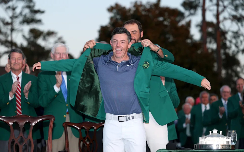 Scottie Scheffler of the United States puts the Green Jacket on Rory McIlroy on April 13, 2025 in Augusta, Georgia.