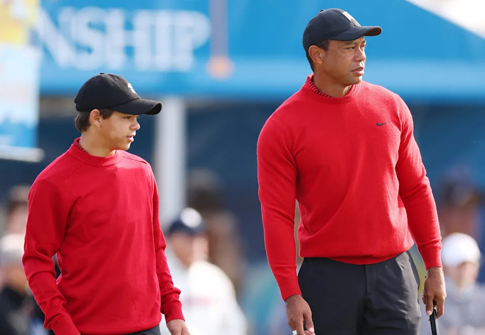 Charlie Woods and Tiger Woods of the United States looks on from the practice green during the final round of the PNC Championship at Ritz-Carlton Golf Club on December 18, 2022 in Orlando, Florida. (Photo by Mike Ehrmann/Getty Images)