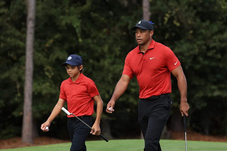 Tiger Woods and Charlie Woods walk from the first green during the final round of the PNC Championship at the Ritz Carlton Golf Club Grande Lakes on December 19, 2021 in Orlando, Florida. (Photo by Sam Greenwood/Getty Images)
