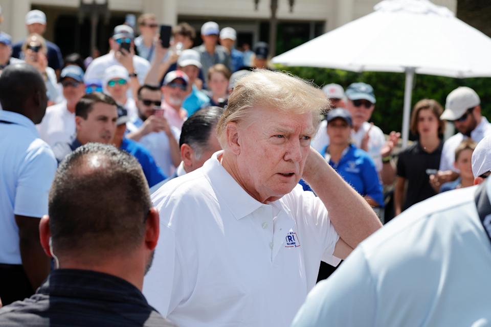Donald Trump walks toward the practice green before the final round of LIV Golf Miami tournament in April 2024. / Reinhold Matay / USA TODAY Sports via Reuters Con