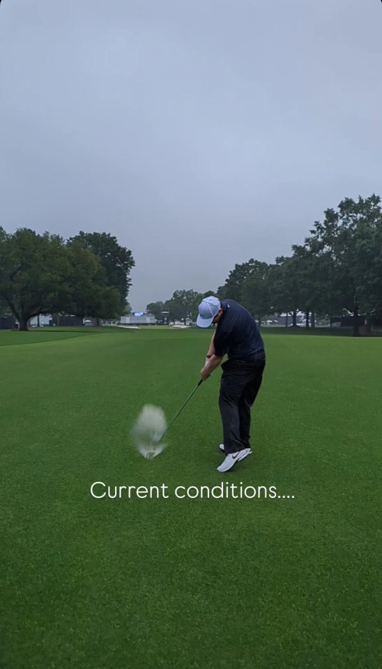 Golfer hitting a golf ball in the rain.