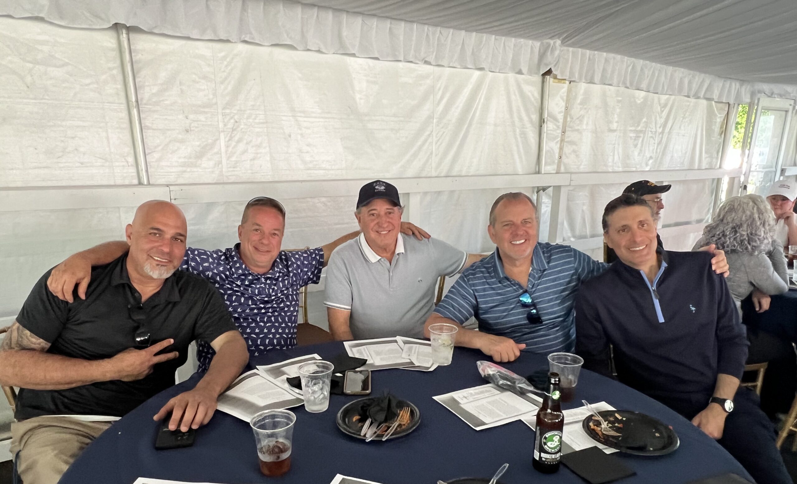 Club members smile for the camera. Photo by Wayne Daren Schneiderman