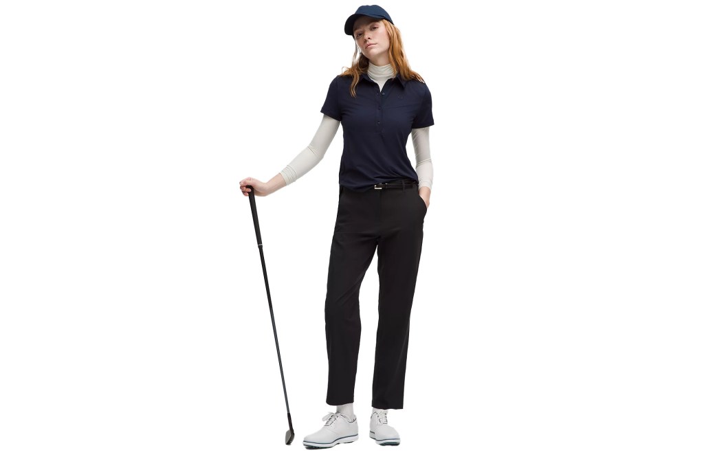 Woman in a golf outfit with a club. 