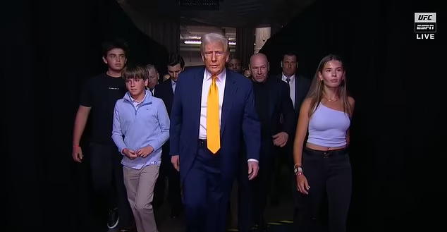 Donald Trump walking with his family and security detail.