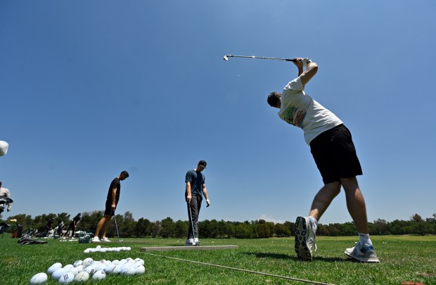 Ryan Brecheen, right, and Dominic Molfetta, center, work out at...