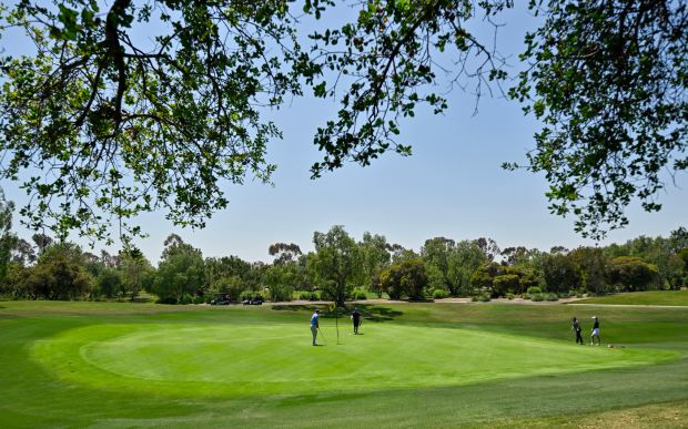 Golfers on the 9th hole at Oak Creek Golf Club...