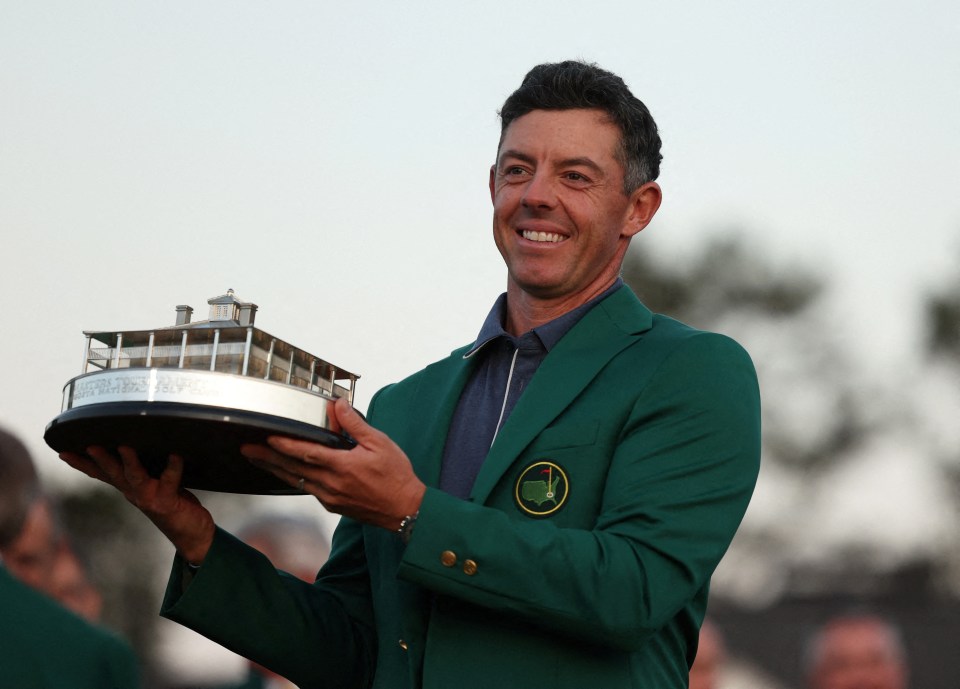FILE PHOTO: Northern Ireland's Rory McIlroy celebrates with his green jacket and the trophy after winning The Masters and completing a career grand slam. Augusta National Golf Club, Augusta, Georgia, U.S., April 13, 2025 REUTERS/Pilar Olivares/File Photo