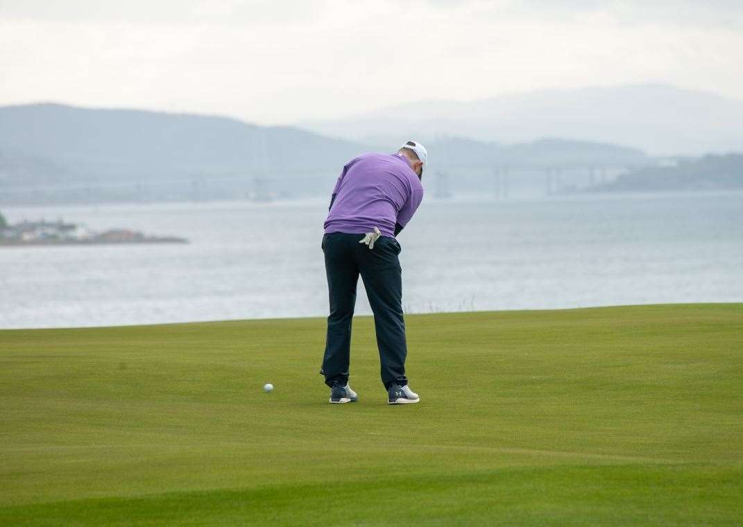 Making a putt, with the Kessock Bridge visible in the far distance. Picture: Cameron Brown/Maggie's Highland.