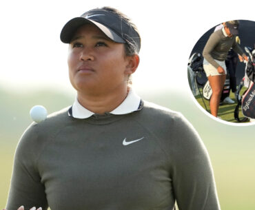 Amari Avery walks to the tee and looks at her golf bag