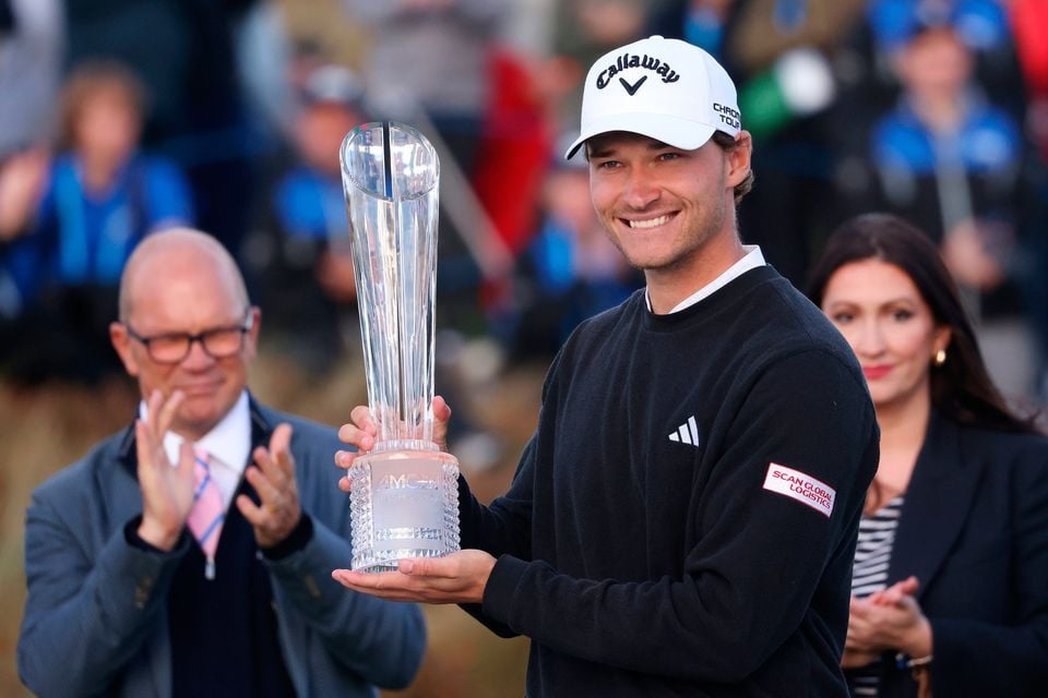 Rasmus Højgaard holds the Irish Open trophy following his victory at Royal County Down