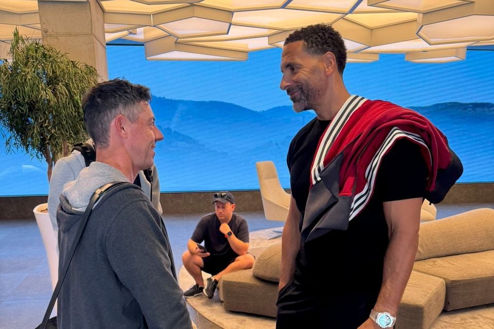 Rory McIlroy greeted by Rio Ferdinand after arriving in Spain ahead of Europa League final.