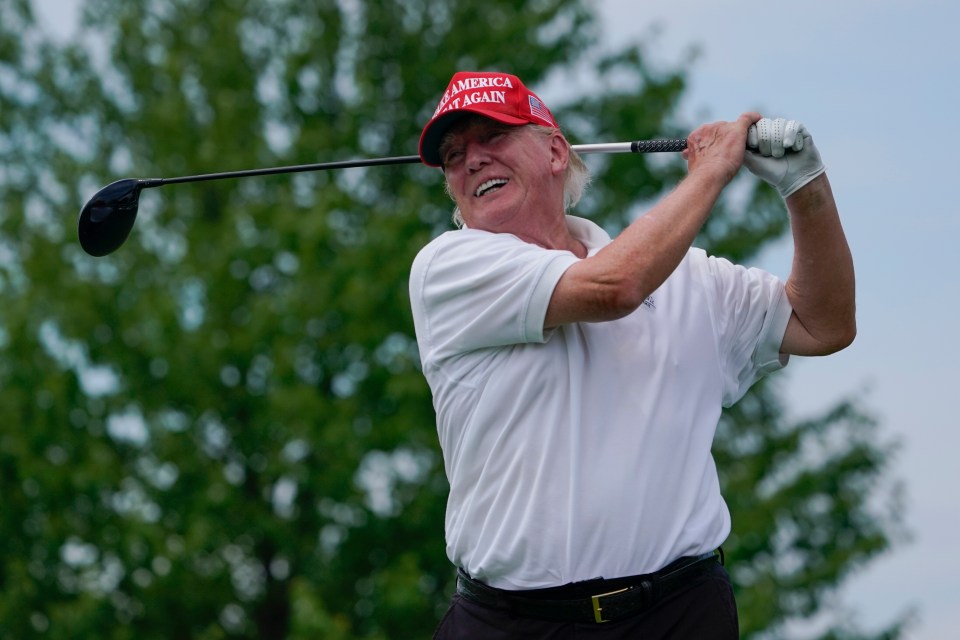 Donald Trump playing golf.