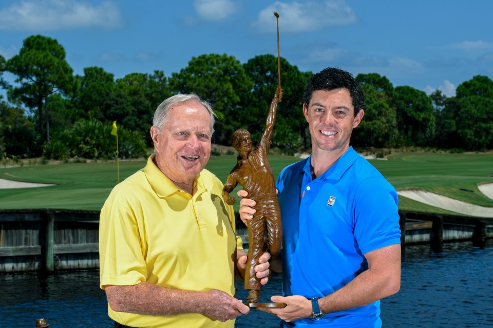 Jack Nicklaus and Rory McIlroy holding a golf trophy.