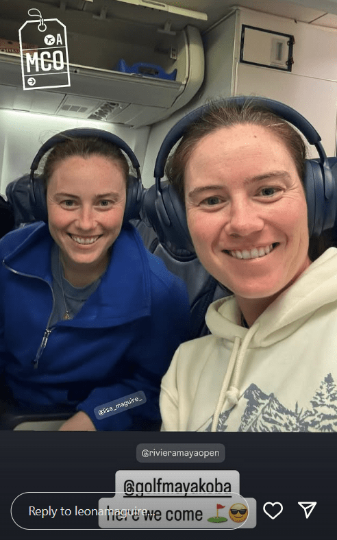 Two women wearing headphones on a plane.