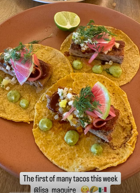 Three tacos with meat, pickled onions, and guacamole.