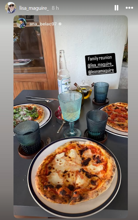 Three pizzas and drinks at a family reunion.