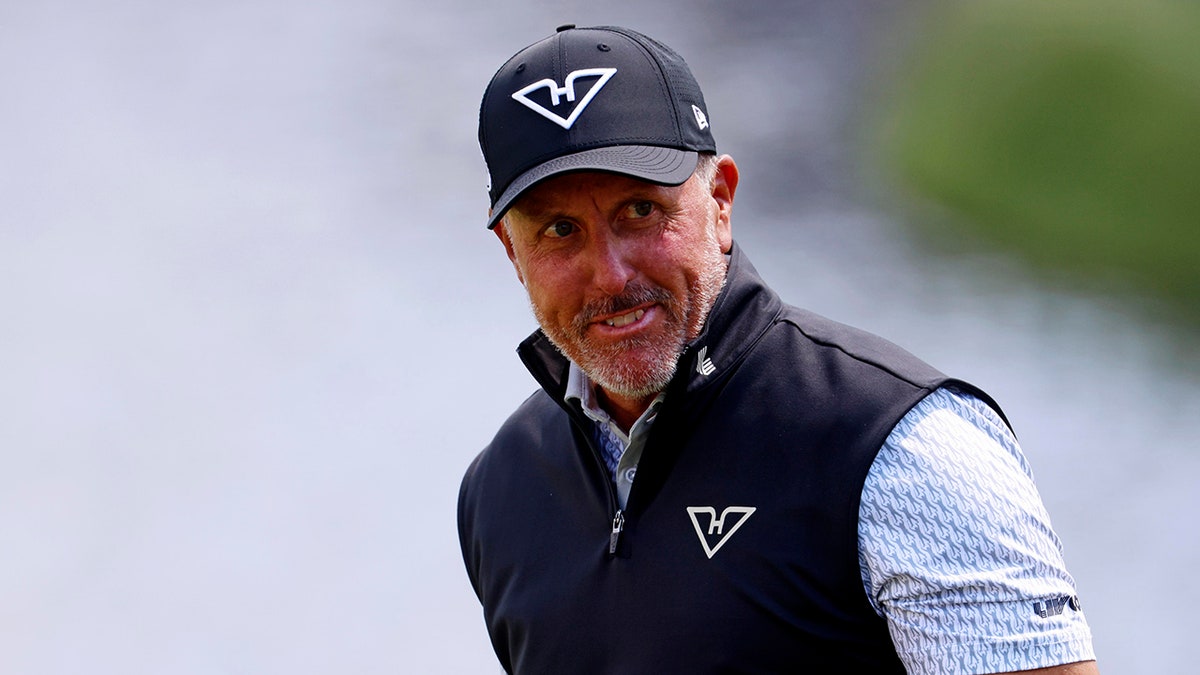 Phil Mickelson looks on