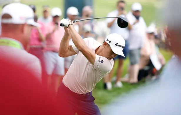 Collin Morikawa swings the golf club
