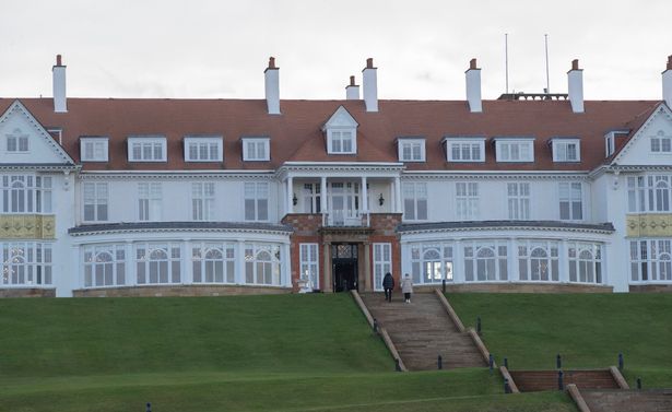 An image of the exterior of a grand white building.
