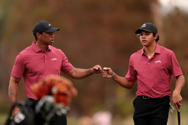 Tiger Woods fist-bumps his son, Charlie