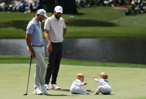 AUGUSTA, GEORGIA - APRIL 09: Scottie Scheffler of the United States and Sam Burns of the United States laugh with their children, Bear Burns and Bennett Scheffler on the fourth green during the Par Three Contest prior to the 2025 Masters Tournament at Augusta National Golf Club on April 09, 2025 in Augusta, Georgia. (Photo by Richard Heathcote/Getty Images)