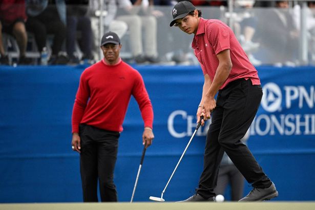 Tiger Woods watches his son, Charlie Woods, putt on the 18th green during the final round of the PNC Championship
