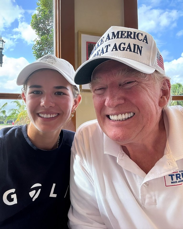 Donald Trump and his granddaughter smiling for a selfie.