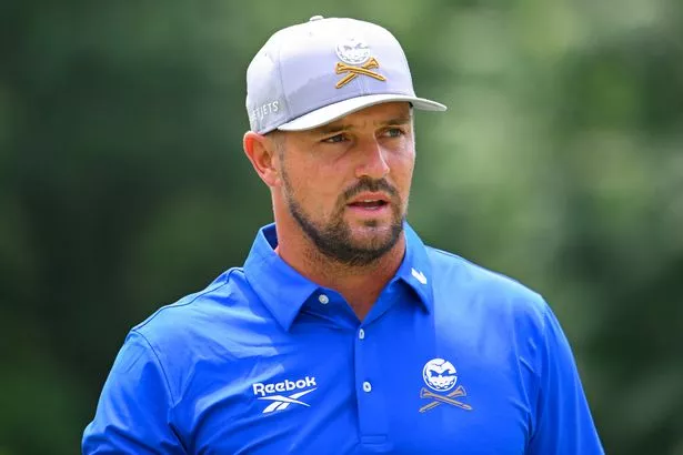 Bryson DeChambeau looks on from the golf course