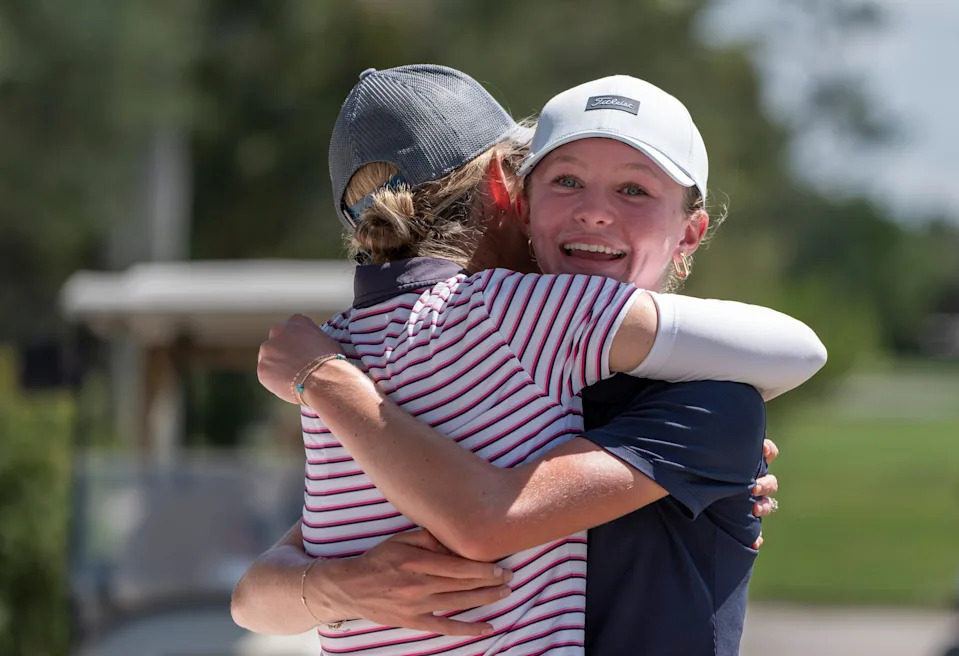 Jupiter's Reese McMillan hugs her mother Jill after winning the 41st Nicklaus Junior Championship at the Tequesta Country Club on June 23, 2025 in Tequesta, Florida.