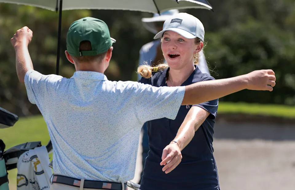 Jupiter's Reese McMillan hugs her brother Jake after she defeated Lake Worth's Bella Simoes in a playoff to to win the girls competition in the 41st Nicklaus Junior Championship at the Tequesta Country Club on June 23, 2025 in Tequesta, Florida.