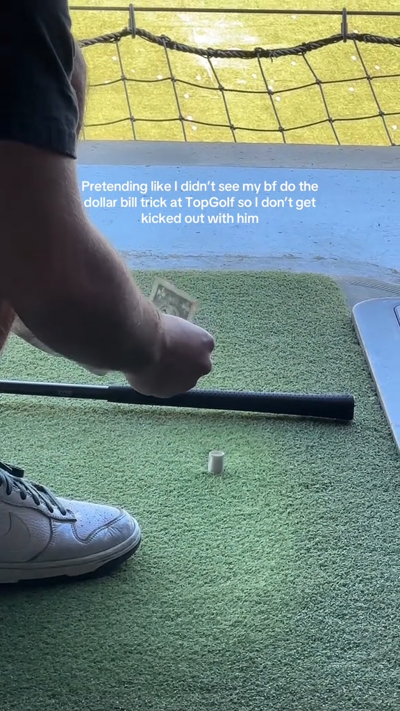 A couple doing the "dollar trick" at TopGolf