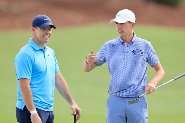 Rory McIlroy of Northern Ireland with Tom McKibbin of Northern Ireland.