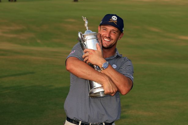 Bryson DeChambeau celebrates winning the U.S. Open by gleefully holding the trophy