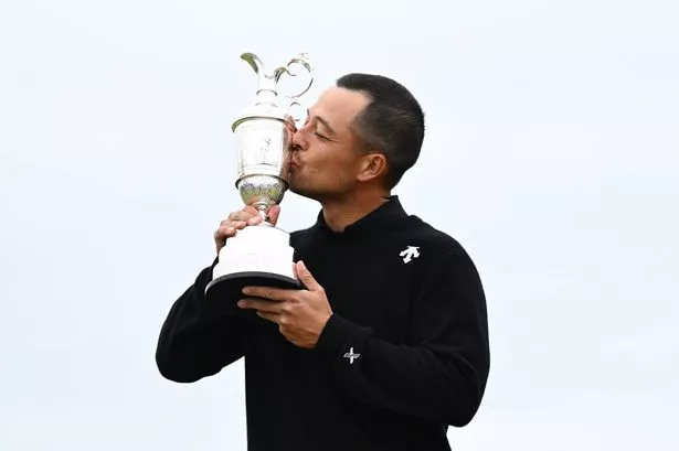 Xander Schauffele of the United States kisses the Claret Jug on the 18th green in celebration of victory on day four of The 152nd Open championship at Royal Troon