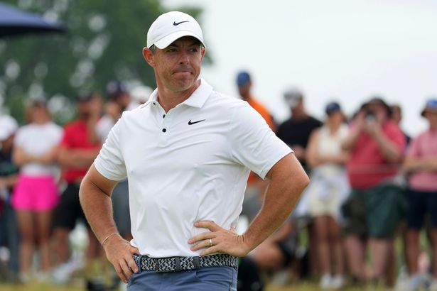 Rory McIlroy looks dejected with his hands on his hips on the green