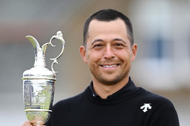Xander Schauffele lifts the Claret Jug on the 18th green in celebration of victory on day four of The 152nd Open championship at Royal Troo