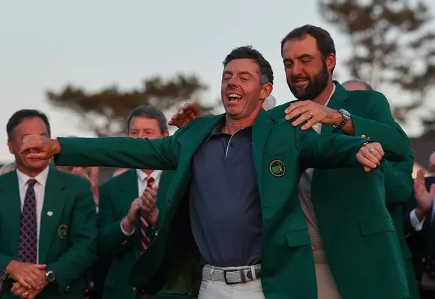Scottie Scheffler giving Rory McIlroy a Green Jacket after his Masters win