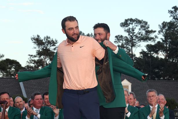 Scottie Scheffler of the United States is awarded the Green Jacket by 2023 Masters champion Jon Rahm