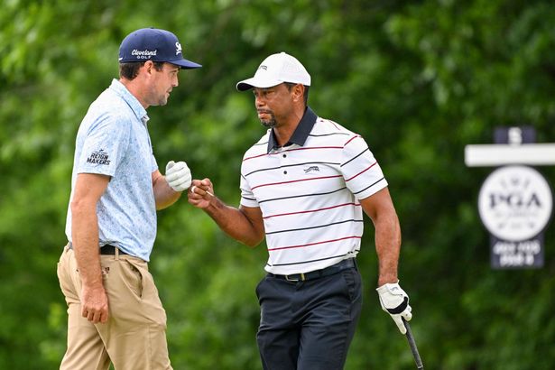 Tiger Woods gets a fist bump from Keegan Bradley after playing a close shot from the eighth hole tee during the second round of the 106th PGA Championship at Valhalla Golf Club on May 17, 2024 in Louisville, Kentucky