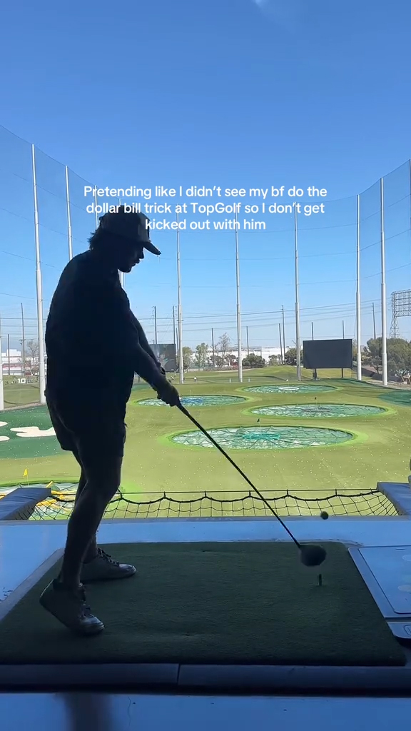 A couple doing the "dollar trick" at TopGolf