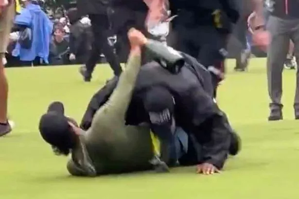 A security guard takes down Adam Hadwin at the Canadian Open in 2023