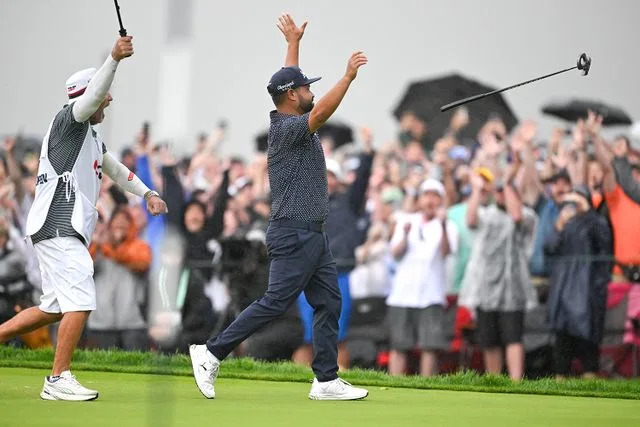 Ben Jared/PGA TOUR via Getty J.J. Spaun (right) on the 18th hole at the U.S. Open on June 15, 2025