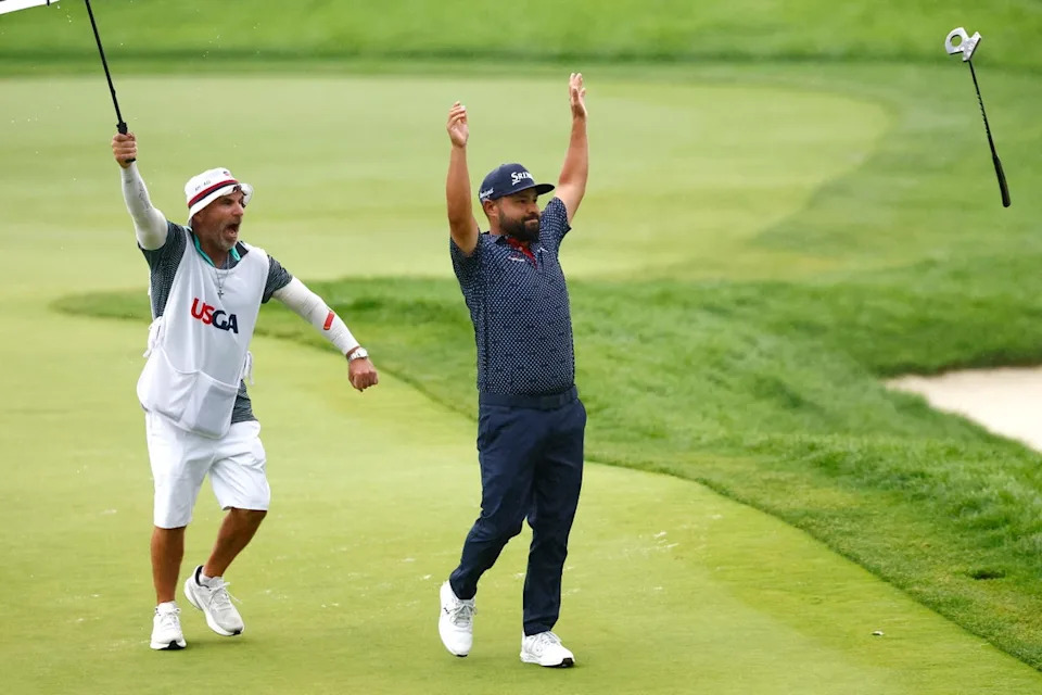 JJ Spaun celebrated victory on the 18th green with caddie Mark Carens (EPA)